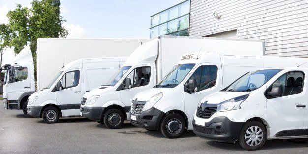 several-vans-trucks-parked-parking-lot-rent_100800-4479