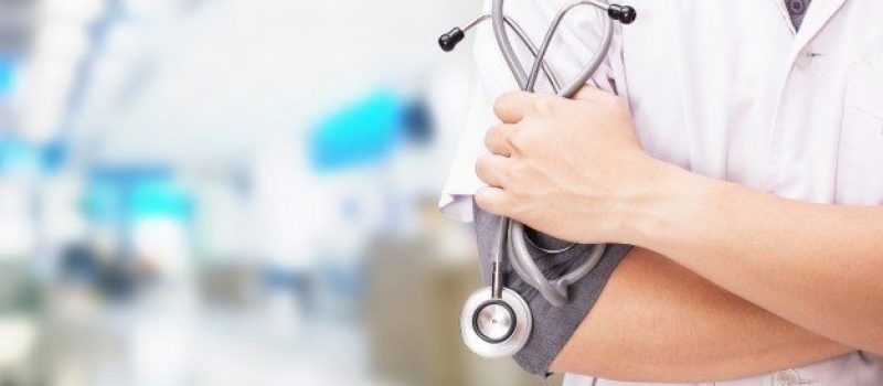 doctor-with-stethoscope-hands-hospital-background_1423-1